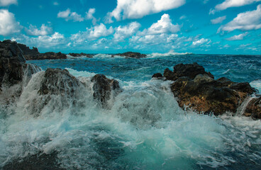 Waves hitting the rocks. Rocky cliffs on sea, seascape.