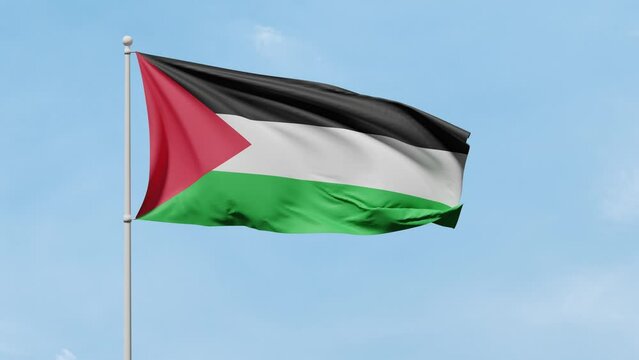 Flag of Palestine with black, white, green stripes and red triangle flutters in the wind against a blue sunny sky