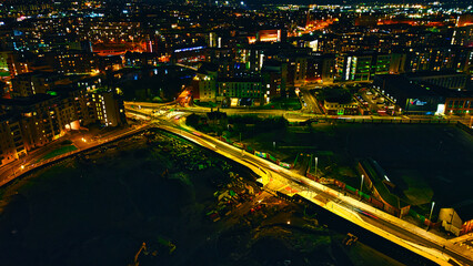 Fototapeta na wymiar Nighttime cityscape with illuminated buildings and streets, showcasing urban architecture and vibrant city life in Leeds, UK.