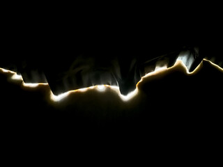 Light ripped across a black surface