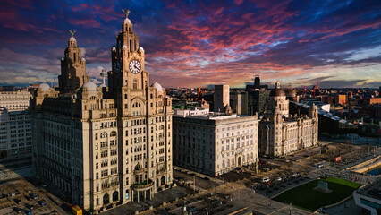 Fototapeta na wymiar Aerial view of iconic Liverpool waterfront buildings at sunset with dramatic sky.
