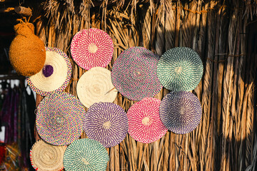 Variety of weaved mats from dried palm leaves, traditional Emirati handicraft at the market
