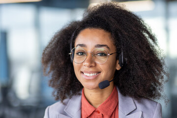 Friendly young woman with headset providing customer support, displaying a cheerful demeanor in a...
