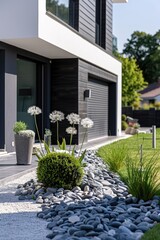 A garden with rocks and plants in front of a house. Suitable for home and garden design concepts.