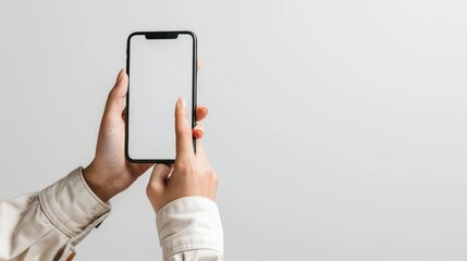 Close-up of a person holding up a smartphone with a white screen. Perfect for technology concepts. - obrazy, fototapety, plakaty