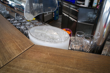 there is a bucket filled with ice cubes in a bar