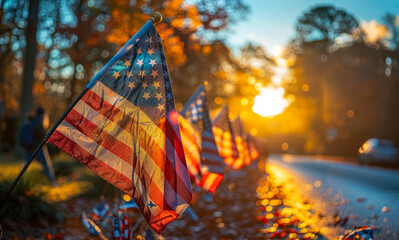 American flags line the street as the sun sets in the background