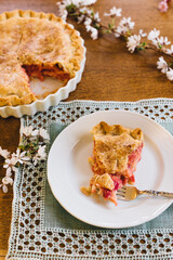slice of rhubarb custard pie on white plate on mint green placemat