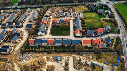 Fototapeta premium Aerial view of a residential construction site with partially completed houses and infrastructure development in Harrogate, North Yorkshire.