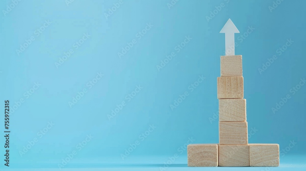 Poster A stack of wooden blocks with an arrow on top. Perfect for business and direction concepts.
