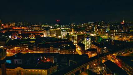 Night cityscape with illuminated buildings and streets, showcasing urban architecture and nightlife in Leeds, UK.