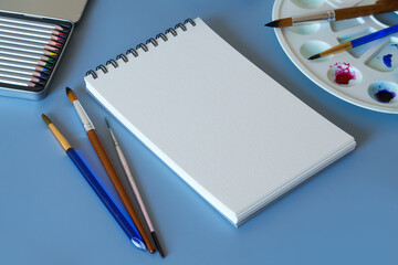 Watercolor painting. Top view of watercolor painting set - watercolor paper, paintbrushes, paints and palette 