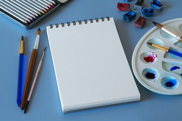 Watercolor painting. Top view of watercolor painting set - watercolor paper, paintbrushes, paints and palette 