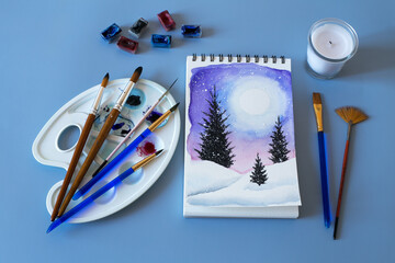 Christmas watercolor. Watercolor winter painting. Top view watercolor painting with a set of brushes, paints and palette 