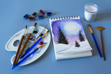 Christmas watercolor. Watercolor winter painting. Top view watercolor painting with a set of brushes, paints and palette 