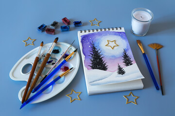 Christmas watercolor. Watercolor winter painting. Top view watercolor painting with a set of brushes, paints and palette 
