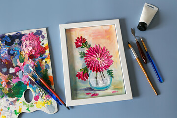 acrylic painting of flowers with palette knife and acrylic paints, artist's hand. Top view	