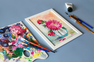 acrylic painting of flowers with palette knife and acrylic paints, artist's hand. Top view	