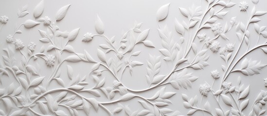 A detailed shot of a white wall with a delicate floral pattern painted on it. The intricate design resembles a frozen water droplet on a twig surrounded by grass, forming a circle in the center