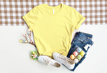 Yellow Shirt Mockup. Blank T-Shirt Mock Up,Shirt Mockup, Front View. With Easter Eggs. Ready To Replace Your Design. template, flat lay , top view, copyspace.