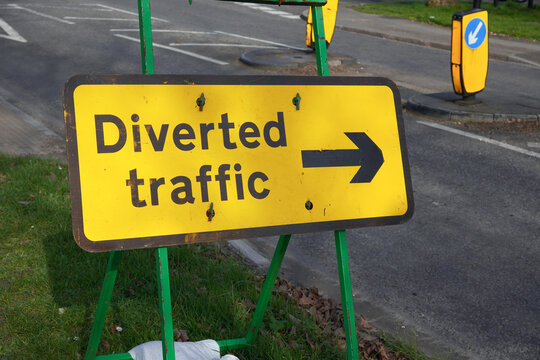 Diverted traffic sign with directional arrow showing reroute. works site with closed road in the UK 