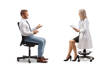 Businessman sitting in an office chair and talking to a female doctor