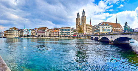 Limmat river with Munsterbrucke bridge and Grossmunster with houses on the river's bank, Zurich,...