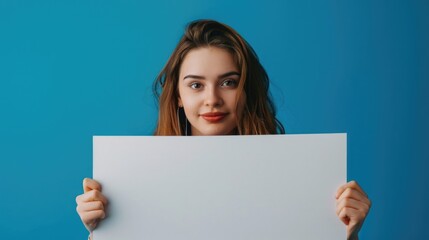 Naklejka premium A woman holding a blank sign, versatile image for advertising.