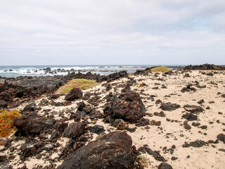 Lanzarote, Spain - June 2, 2018: Caleta del Mojón Blanco, white sand and lava rocks