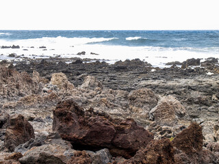 Lanzarote, Spain - June 2, 2018: Caleta del Mojón Blanco, white sand and lava rocks