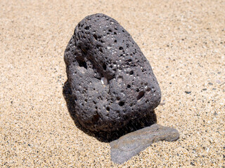 Playa Del Pozo stone on sandy beach