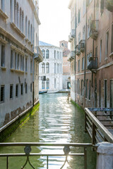 Sunlit Canal between Historic Venetian Buildings