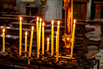 Lit Candles Offering Peaceful Ambiance in Venetian Church Setting