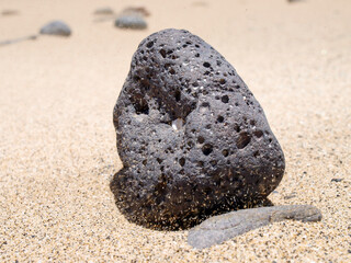 Fototapeta na wymiar Playa Del Pozo stone on sandy beach