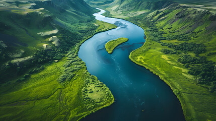 An aerial perspective showcases a river meandering through a valley embraced by towering mountains, enhancing the natural landscape with fluvial landforms and lush grasslands - obrazy, fototapety, plakaty