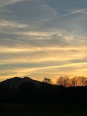 Sunset sky over the mountains and the trees near Tabagón, O Rosal, Galicia, Spain, January 2023