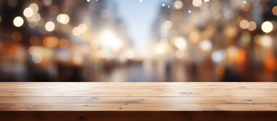 A hardwood table with a dark wood stain is in focus against a blurred background, possibly of plants and the sky. The table is made of sturdy planks and has a circular design