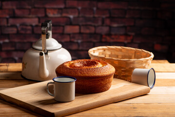 Orange cake, beautiful orange cake and accessories on rustic wooden surface, dark background, selective focus.