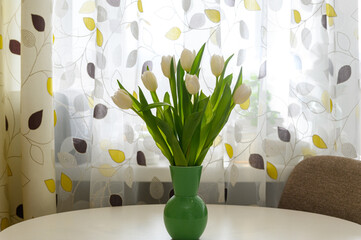 White tulips in a vase on a white table. - 756002943