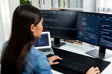 Young Asian in IT developer creating with typing online information on pc with coding program data...