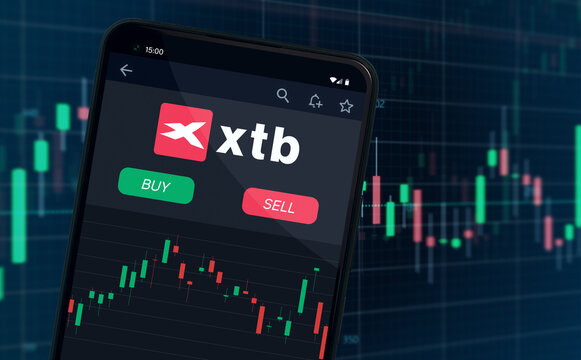 XTB online stock broker company shares rise or fall on stock exchange market - logo in trading app on mobile phone screen - Warsaw, Poland - 11.03.2024