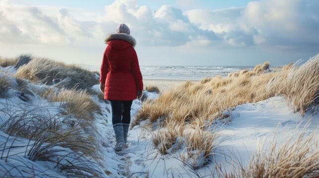 A Senior woman walking in sandy winter beach at sunny day. AI generated image