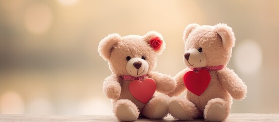 Two stuffed toy teddy bears with soft fur are sitting next to each other on a table, each holding a heart. The baby toys are in shades of magenta and carmine