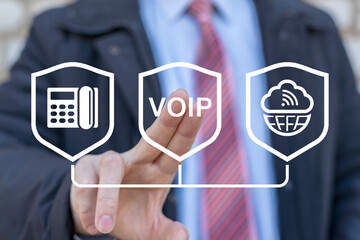 Concept of VOIP telecommunication. Business man using virtual touch screen presses abbreviation:...