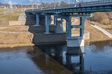 Fototapeta na wymiar steel frame and concrete construction huge car bridge across the wide river