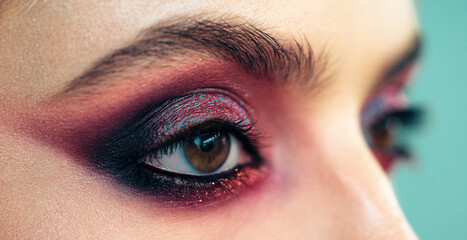 Professional smokey eyes make up at beautiful girl for special occasion. Shiny glitter pigments in...