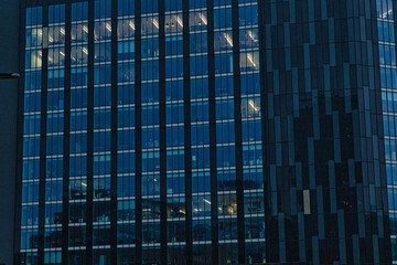 Modern office building facade with reflective glass windows at dusk in Leeds, UK.