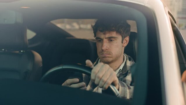 Disappointed stressed sad man Caucasian auto driver businessman inside automobile car waiting in traffic jam using mobile phone read bad news upset displeased loss gps navigation road driving in city