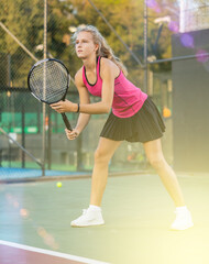 Sports girl is ready to repel an attack while playing tennis