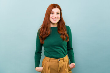 Happy woman with red hair smiling looking at the camera